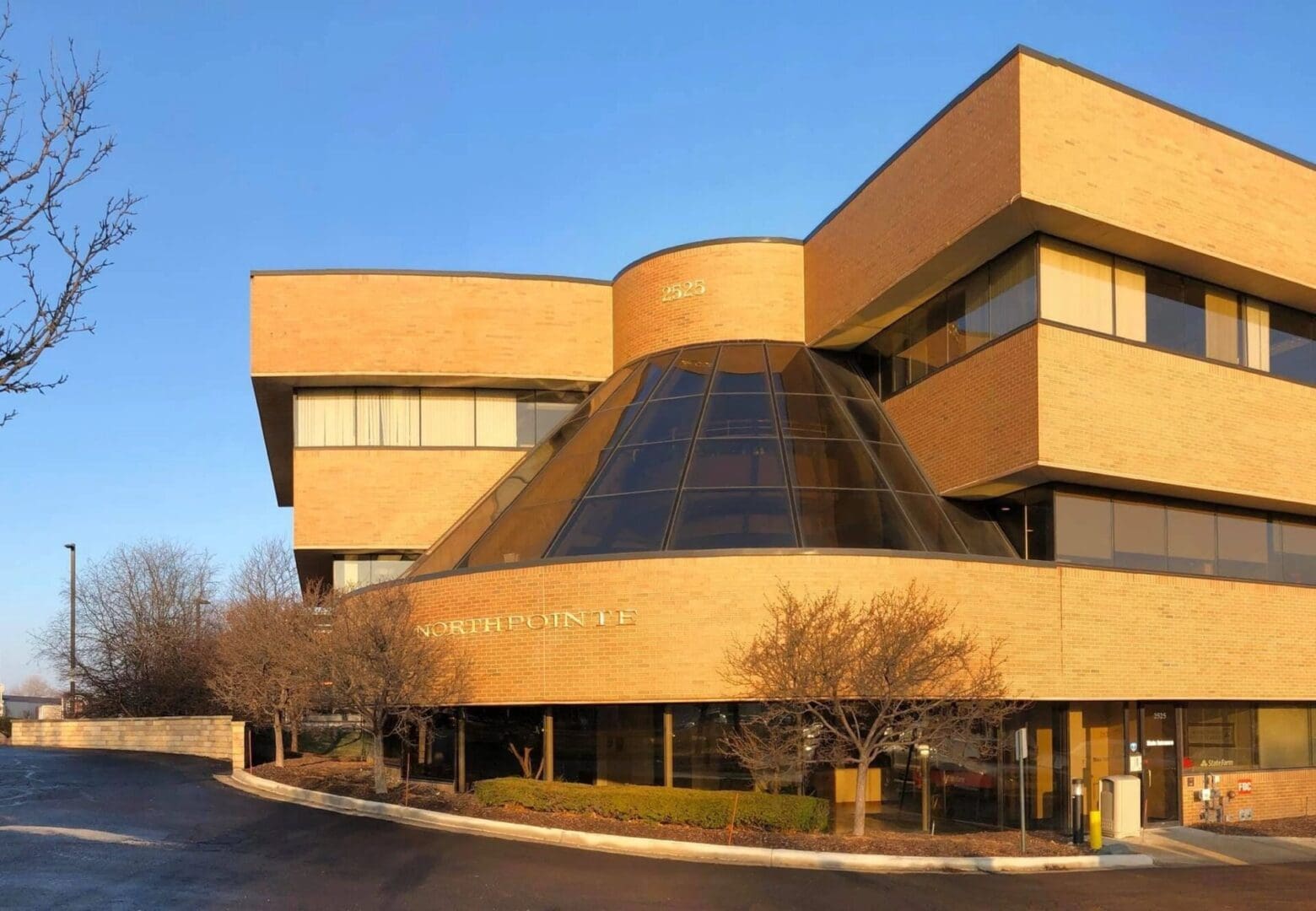 A building with a large glass window on the top of it.